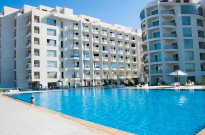 a swimming pool in front of two large buildings at Sea view studio in Hurghada