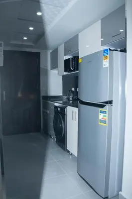 a kitchen with a white refrigerator and a stove at Sea view studio in Hurghada