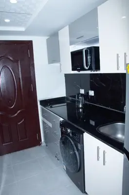 a kitchen with a sink and a microwave at Sea view studio in Hurghada
