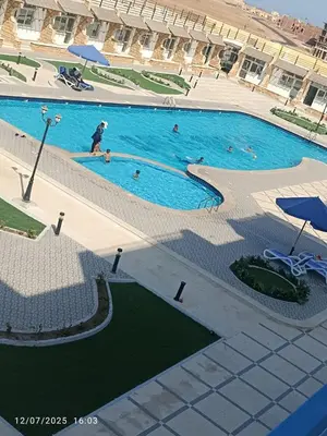 a large swimming pool with people swimming in it at Luxuries Studios and apartments in Oasis Marina ,Hurghada in Hurghada