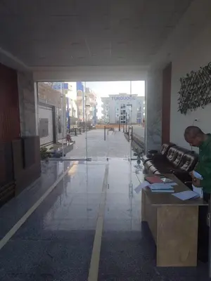 a man standing at a desk in a lobby at Luxuries Studios and apartments in Oasis Marina ,Hurghada in Hurghada