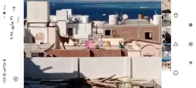two photographs of a city with buildings and the ocean at flat in Hurghada Sheraton Metro street in Hurghada