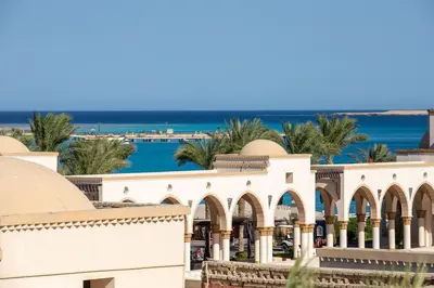 a view of a building with the ocean in the background at Palm Beach Piazza Sahl Hasheesh One bedroom apartment A 401 by Peaks in Sahl Hasheesh