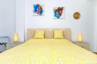 a bedroom with a large bed with two lamps on tables at Palm Beach Piazza Sahl Hasheesh One bedroom apartment A 401 by Peaks in Sahl Hasheesh