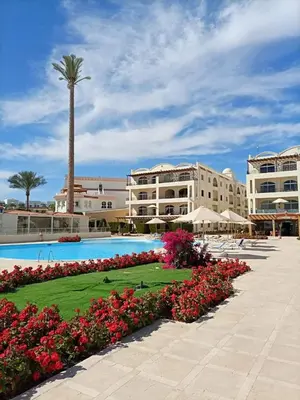 a resort with a swimming pool and a palm tree at Palm Beach Piazza Sahl Hasheesh One bedroom apartment A 401 by Peaks in Sahl Hasheesh