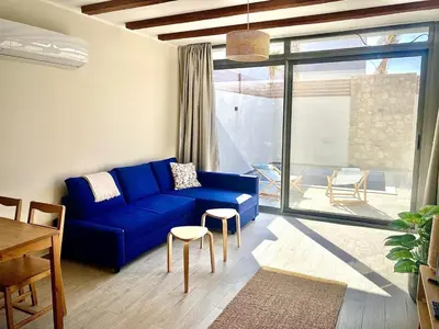 a living room with a blue couch and a table at Gouna Retreat with Private Pool in Bali in Hurghada