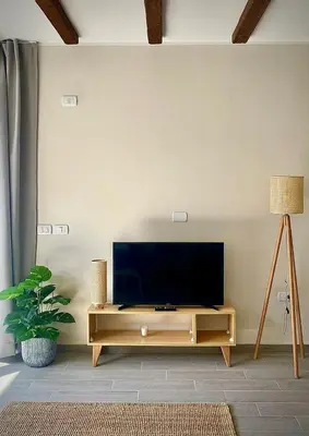 a flat screen tv on a wooden stand in a living room at Gouna Retreat with Private Pool in Bali in Hurghada