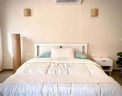 a bedroom with a large white bed in a room at Gouna Retreat with Private Pool in Bali in Hurghada