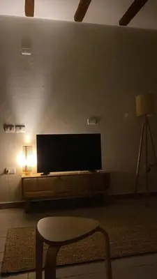 a living room with a flat screen tv on a wall at Gouna Retreat with Private Pool in Bali in Hurghada