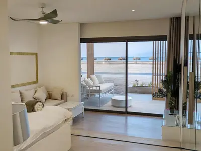 a bedroom with a bed and a view of the beach at Beachfront Somabay Cabana Steps From Sea & Pool in Hurghada