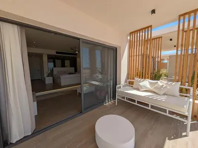 a living room with a white couch and a bedroom at Beachfront Somabay Cabana Steps From Sea & Pool in Hurghada