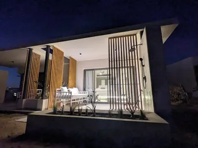a front door of a house with two chairs at Beachfront Somabay Cabana Steps From Sea & Pool in Hurghada