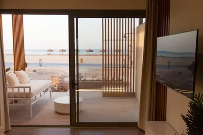 a living room with a view of the beach at Beachfront Somabay Cabana Steps From Sea & Pool in Hurghada