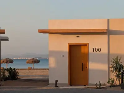 a small building with a door on the beach at Beachfront Somabay Cabana Steps From Sea & Pool in Hurghada