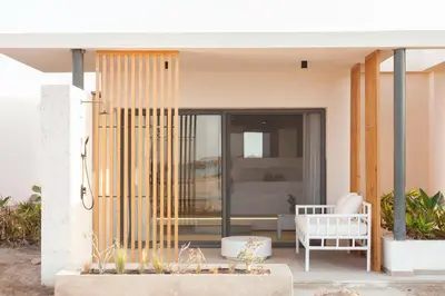 a house with a white chair on a porch at Beachfront Somabay Cabana Steps From Sea & Pool in Hurghada