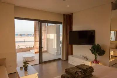 a bedroom with a bed and a view of the beach at Beachfront Somabay Cabana Steps From Sea & Pool in Hurghada