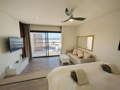a bedroom with a bed and a view of the ocean at Beachfront Somabay Cabana Steps From Sea & Pool in Hurghada