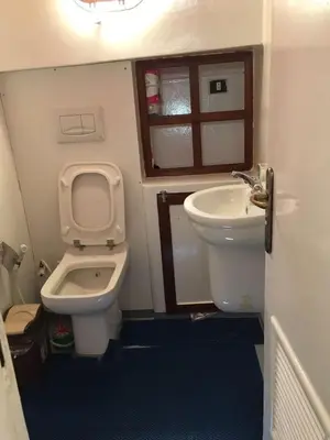 a small bathroom with a toilet and a sink at ايجبت تورز in Luxor