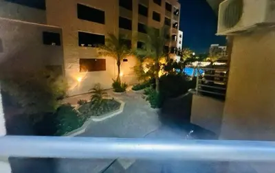 a view from a balcony of a building at night at Zuni in Hurghada