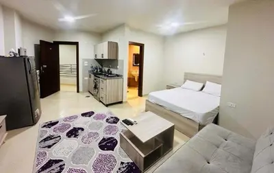 a bedroom with a bed and a couch in it at Zuni in Hurghada
