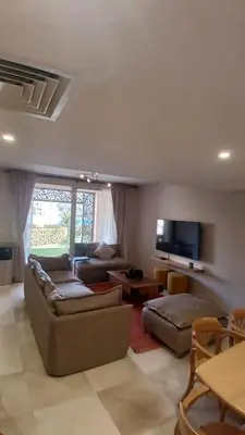 a living room with two couches and a tv at Mangroovy Gouna Beach and pool in Hurghada