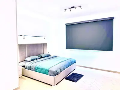 a bedroom with a large screen and a bed at Al Saraya Sahl Hasheesh by Peaks One Bedroom Apartment With Pool View B405&A410 in Hurghada