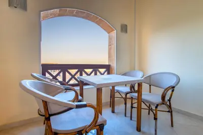 a table and chairs in a room with a mirror at Al Saraya Sahl Hasheesh by Peaks One Bedroom Apartment With Pool View B405&A410 in Hurghada