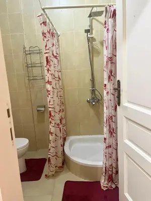 a bathroom with a shower and a tub and a toilet at Your city hotel in a private location! in Hurghada
