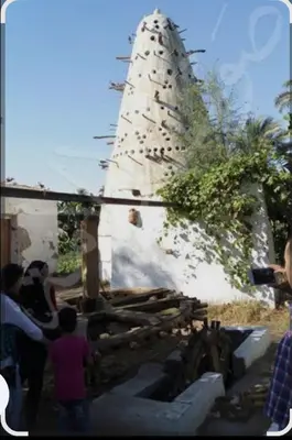 a group of people standing in front of a building at Elbess For Tourism in Jazīrat al ‘Awwāmīyah