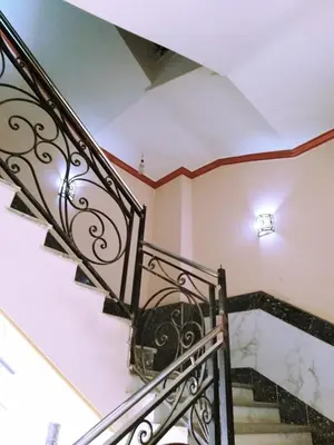 a staircase with a wrought iron railing in a house at Sheraton Plaza Hurghada in Hurghada
