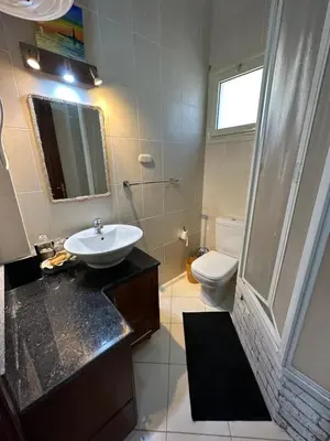 a bathroom with a sink and a toilet at Luxury cozy apartment in Hurghada
