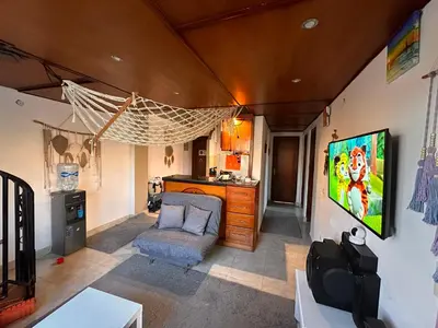 a living room with a hammock hanging from the ceiling at Luxury cozy apartment in Hurghada