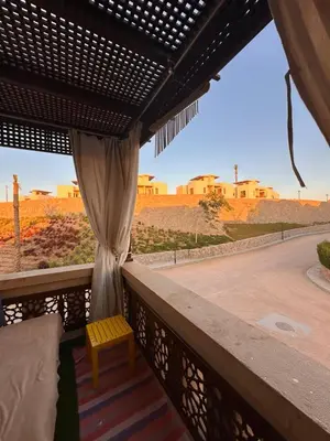 a room with a balcony with a view of the desert at Luxury cozy apartment in Hurghada