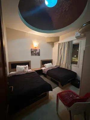 a room with two beds and a round ceiling at Luxury cozy apartment in Hurghada