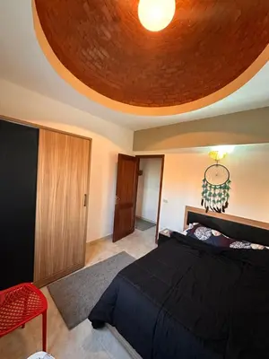 a bedroom with a large bed and a ceiling at Luxury cozy apartment in Hurghada