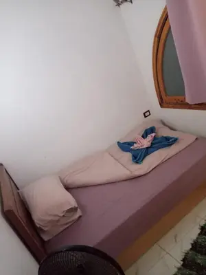 a small bed in a room with a mirror at Talamermaid in Hurghada