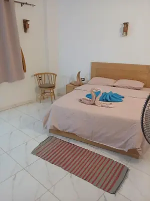 a bedroom with a bed with two towels on it at Talamermaid in Hurghada