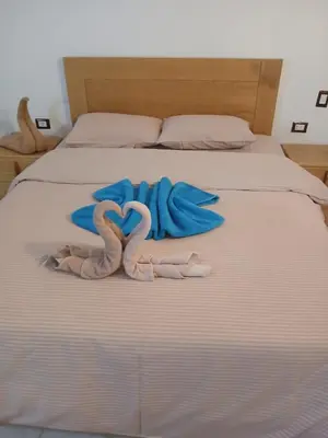 two towels in the shape of hearts on a bed at Talamermaid in Hurghada