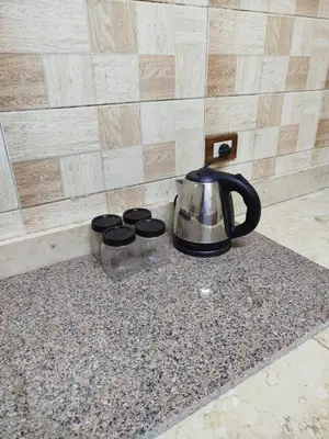 a tea kettle sitting on a counter next to a wall at Luna Nile in Aswan