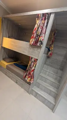 a bunk bed with a staircase in a room at Hostify Hostel and Rooftop in Hurghada