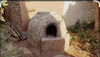 a brick oven sitting in the grass in a yard at Elbess For Tourism in Al Karnak