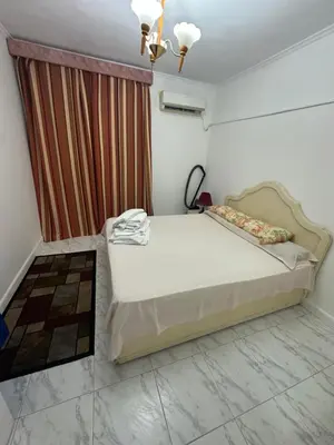 a bedroom with a bed in a room with a curtain at Paradise Villa in Hurghada