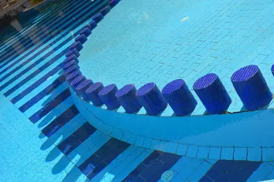 a swimming pool with blue and purple columns in it at كمباوند فلورنزا خمسين Florenza Khamsin in Hurghada