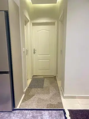 an empty hallway with a white door and a rug at كمباوند فلورنزا خمسين Florenza Khamsin in Hurghada