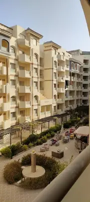 a view of some buildings with chairs and tables at كمباوند فلورنزا خمسين Florenza Khamsin in Hurghada