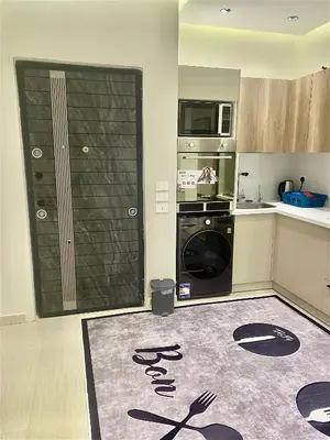 a kitchen with a washer and dryer and a microwave at كمباوند فلورنزا خمسين Florenza Khamsin in Hurghada
