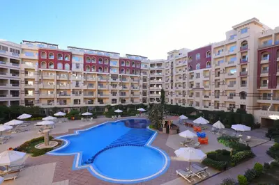 a large apartment building with a large swimming pool at كمباوند فلورنزا خمسين Florenza Khamsin in Hurghada