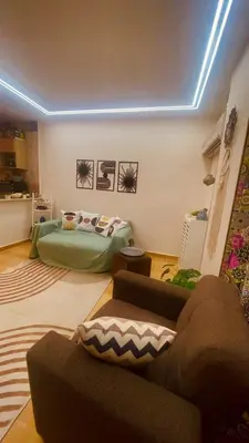 a living room with a bed and a couch at Chill & Cozy Stay in Hurghada