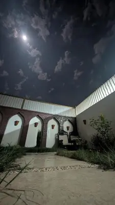 a building with a moon in the sky at The Village House with Private Garden - Four Bedroom Nubian Home on Luxor West Bank in Luxor