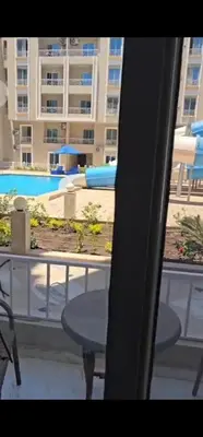 a table and chairs on the balcony of a building at Hurghada Hub in Hurghada